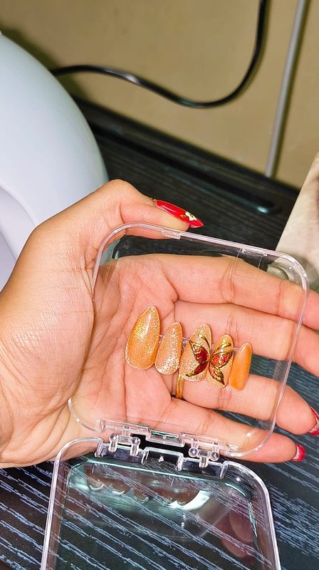 Orange glitter butterfly nail art
